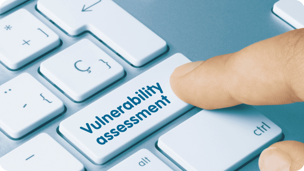 A man clicking vulnerability assessment on a keyboard